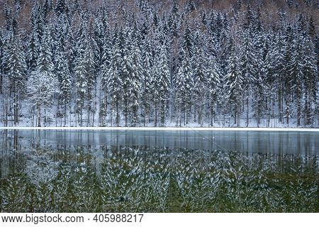 Frozen Winter Lake In The Mountains Covered With Snow. Plansar Lake, Jezersko Slovenia.