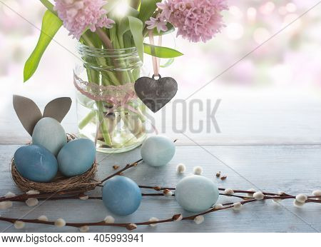 Spring Easter Decoration With Pink Flowers And Pastel Blue Eggs. Space For Text. Close Up With Short