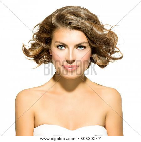 Beauty Young Woman Portrait Isolated over White Background. Beautiful Spa Model Girl Looking at Camera. Short Curly Hair, Fresh Clean Skin and Blue Eyes. Hairstyle. Haircut 