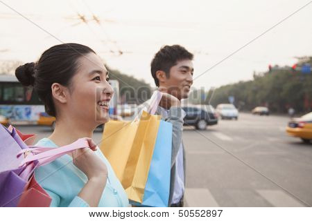 Young couple walking down the street with shopping bags in Beijing