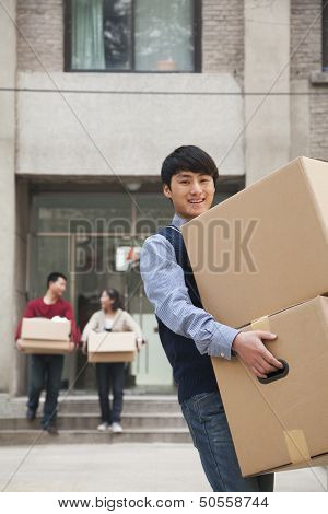 Family moving boxes out of a dormitory at college