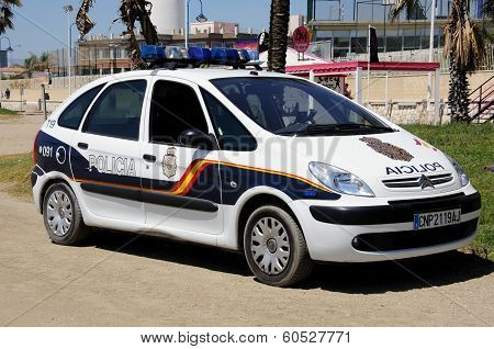 Police car by beach, Malaga, Spain.