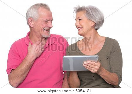 Senior couple with tablet computer in front of white background