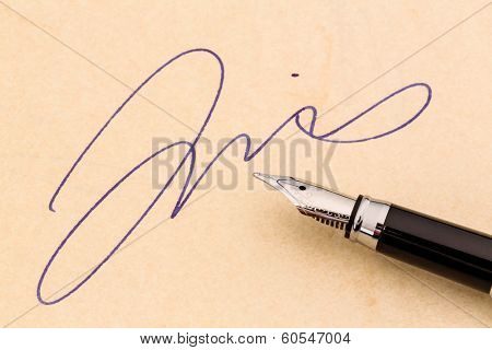 a signature and a fountain pen on yellow paper. symbolic photo for contract testament and graphology