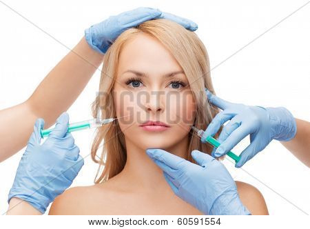 beauty and cosmetic surgery concept - woman face and beautician hands with syringes