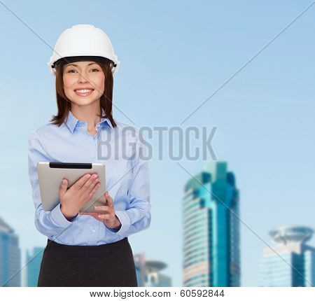 building, developing, consrtuction and architecture concept - friendly young smiling businesswoman in white helmet