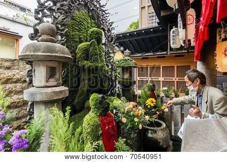 OSAKA, JAPAN - APRIL 18th  :Fudo covered with moss and water washout in Hozenji, Osaka, Japan on 18th April 2014.