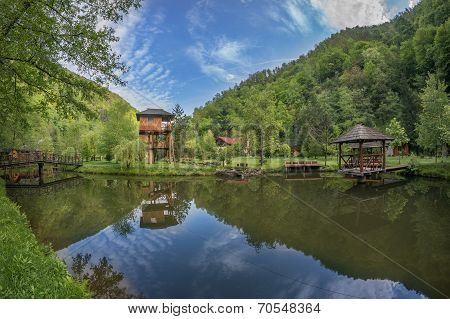 Suspended Cottage Near Pond With Small Pontoon