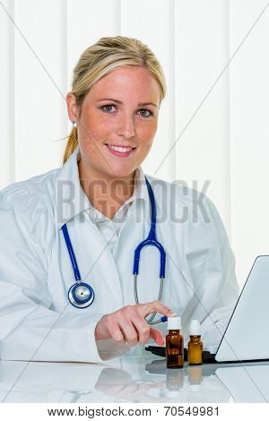 portrait of a young, sympathetic female doctor in their doctor's office. smile bestows confidence.
