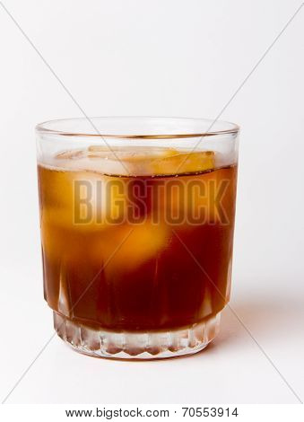 glass with ice tea full with ice cubes