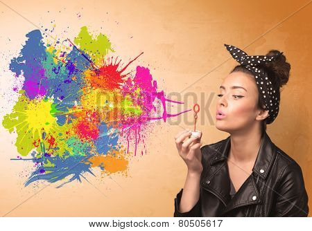 Cute girl blowing bubble spalsh graffiti into wall