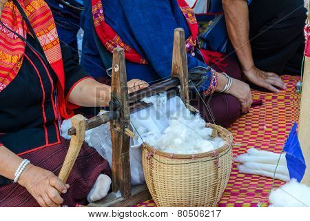 Woman Spinning Cotton With A Spinning Wheel