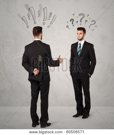 Ruthless businessman handshake with drawn exclamation and question marks around them head