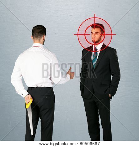 Ruthless businessman handshake with a hiding weapon and a head target point 