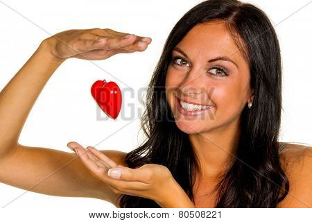 a young woman holding a love heart in hand