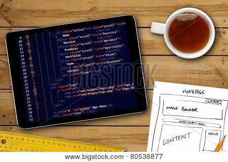 Website Wireframe Sketch And Programming Code On Digital Tablet Screen