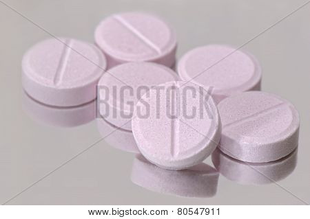 Pink pills on the mirror surface