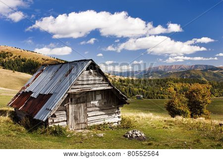 Woody Chalet On The Mountains With Sky And Clouds