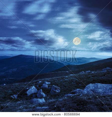 Mountain Hillside With White Boulders At Night