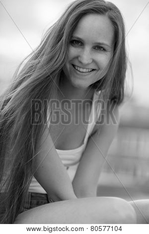 Smiling young women sitting outdoor