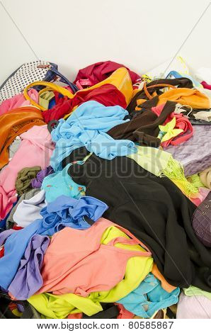 Close Up On A Big Pile Of Clothes And Accessories Thrown On The Ground.