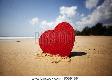 Red heart on exotic sandy beach - Valentine's day concept