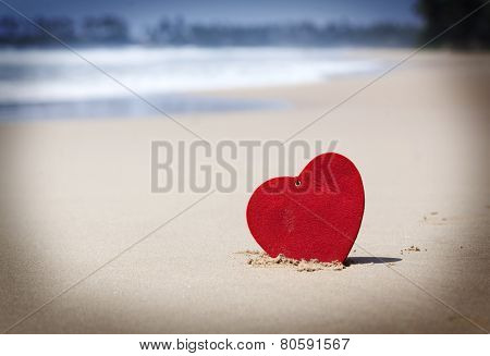 Red heart on exotic sandy beach - Love concept