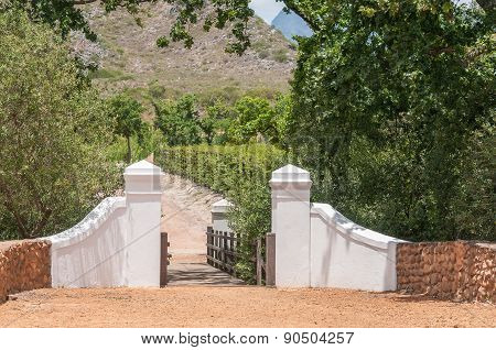Boundary Wall And Wooden Bridge