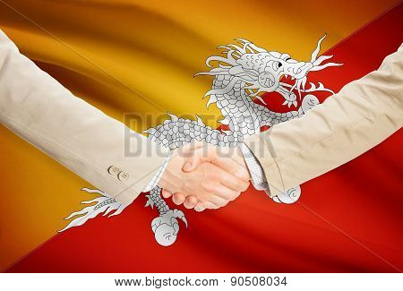 Businessmen Handshake With Flag On Background - Bhutan