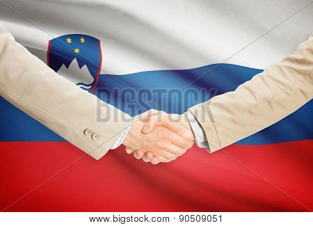 Businessmen Handshake With Flag On Background - Slovenia