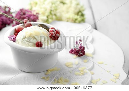 Beautiful composition with tasty ice cream and lilac flowers