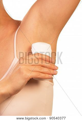 Woman applying deodorant