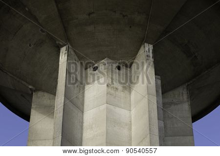Water tower from below against blue sky