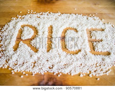 Rice word made of rice on wooden board