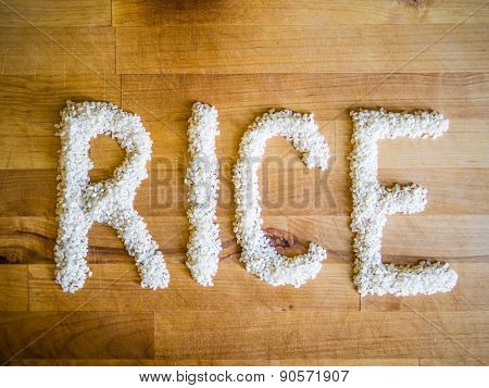 Rice word made of rice on wooden board