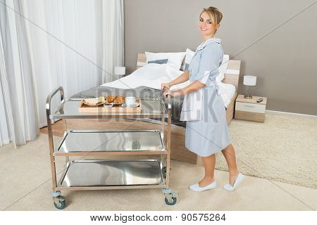 Woman Pushing Trolley With Breakfast