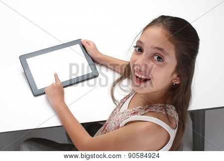 Beaitiful pre-teen girl using a tablet computer.