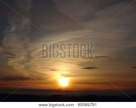 Sunset on winter field and blue colors in the sky