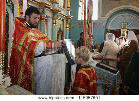 LUTSK UKRAINE - NOVEMBER 02 - Priest and little sexton during holiday prayers in Lutsk on November 02 2008.