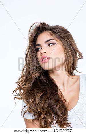 Portrait of a beautiful woman with long curly hair posing isolated on a white background