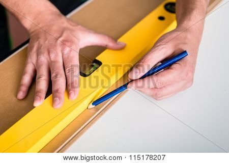 Workman with air level flooring home