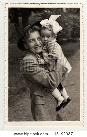 Vintage photo of a small girl with her aunt, circa 1941.