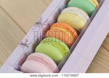Colorful Macaroons Boxset On Wooden Background.