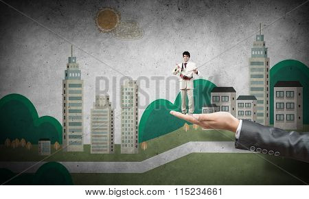 Palm supporting businessman