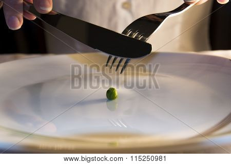 Girl Is Eating One Green Pea