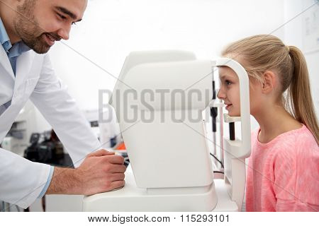 optician with tonometer and patient at eye clinic