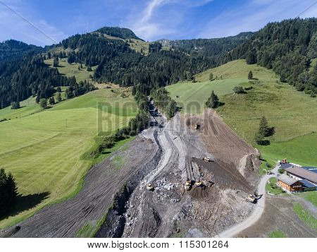 Men And Equipment Cleaning Up After The Mudslides