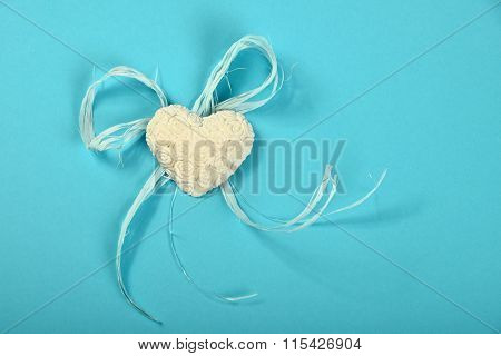 Gypsum Heart With Flowers And Ribbon On Blue Background