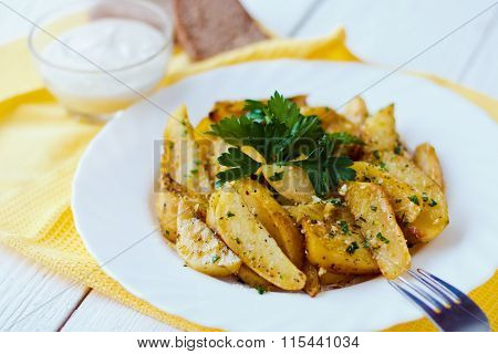 Beautiful Roasted Potatoes With Herbs And Spices On A White Plate