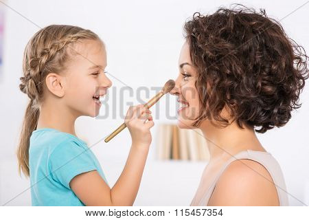 Mom and daughter are having fun.